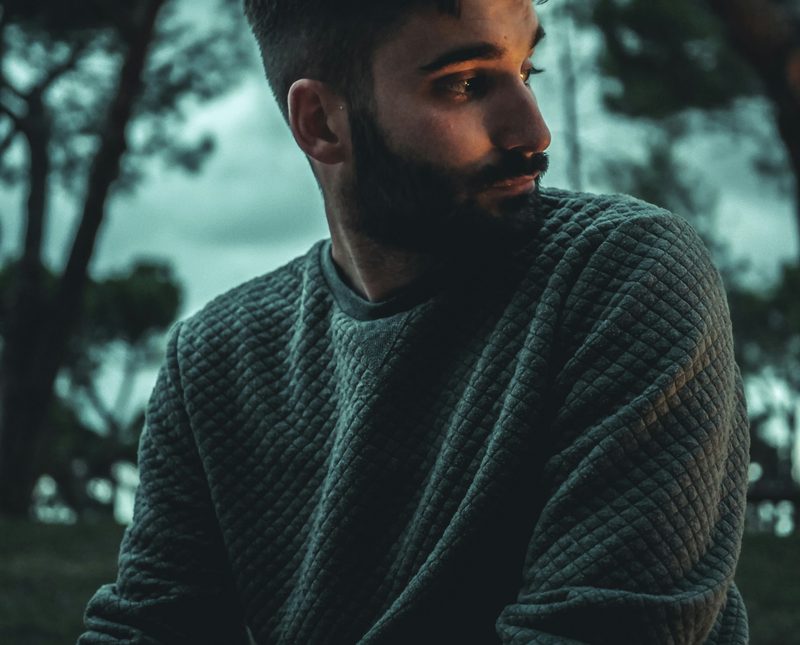 Man wearing sweater in the woods