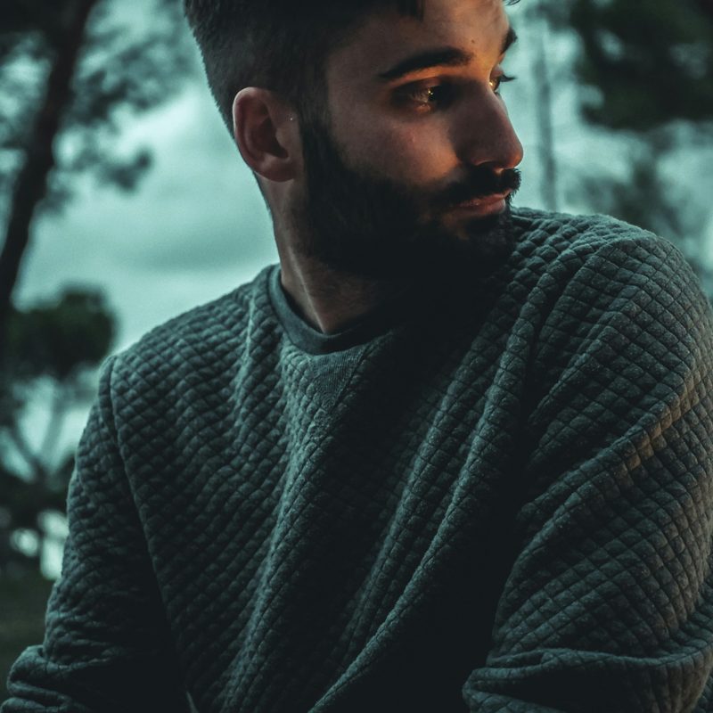 Man wearing sweater in the woods