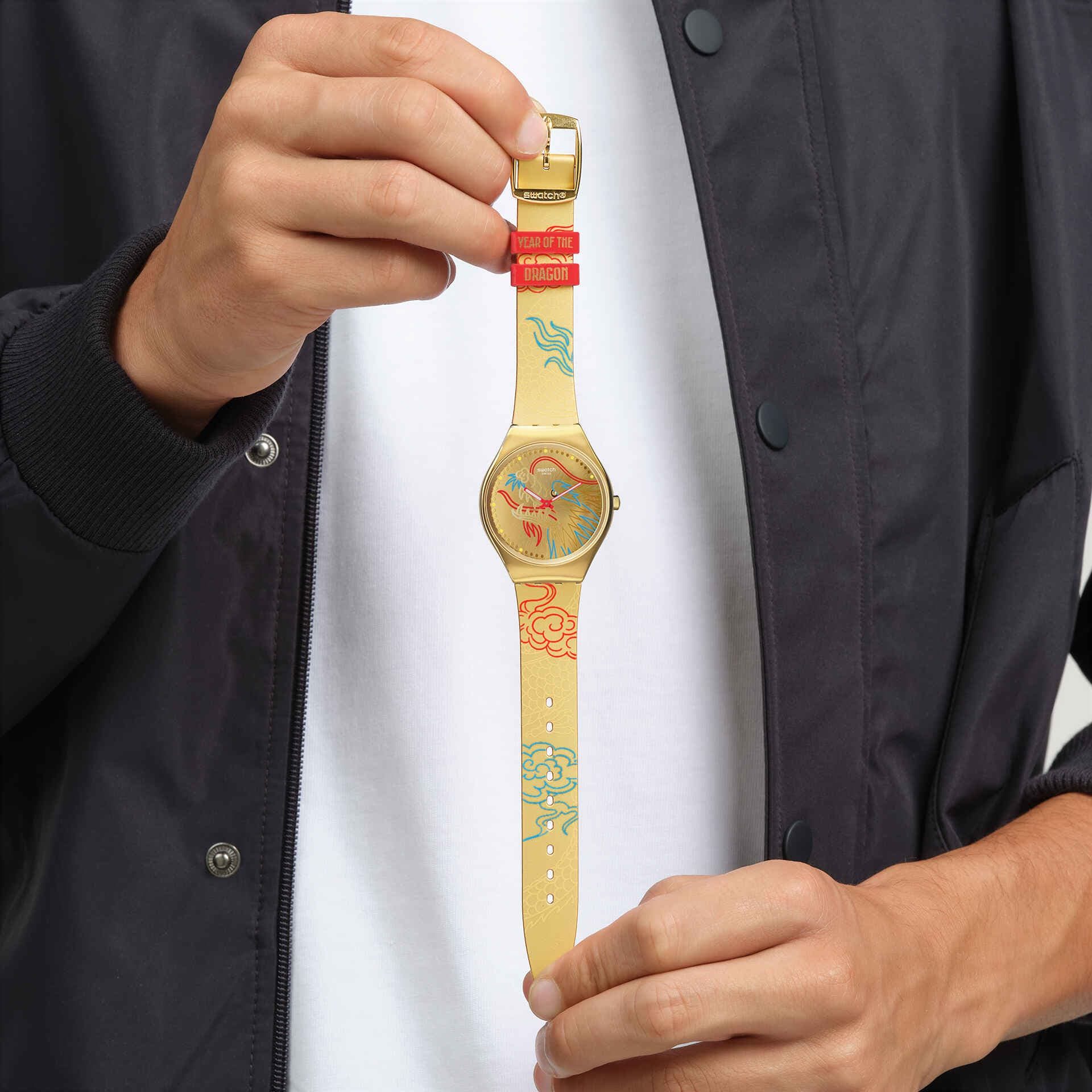 Swatch Dragon in Gold held up
