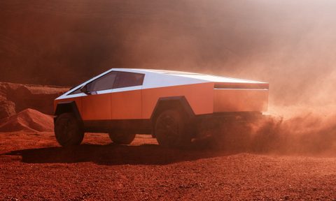 Tesla Cybertruck driving in the desert.