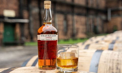 Traveller Whiskey with a glass of it next to the bottle