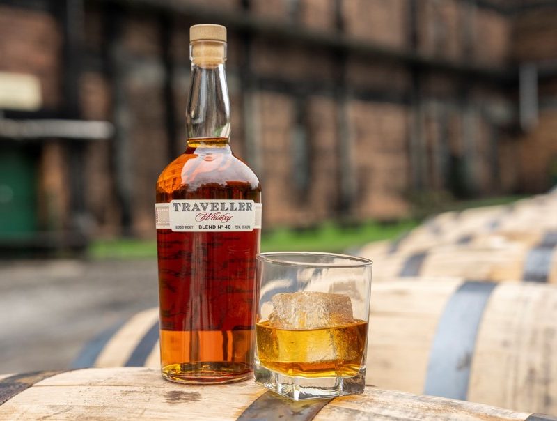 Traveller Whiskey with a glass of it next to the bottle