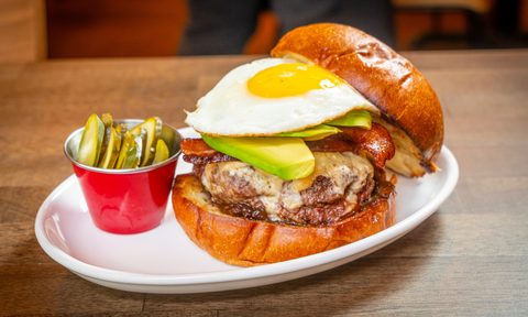 Burger with egg on plate.