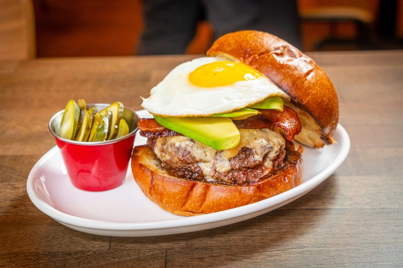 Burger with egg on plate.