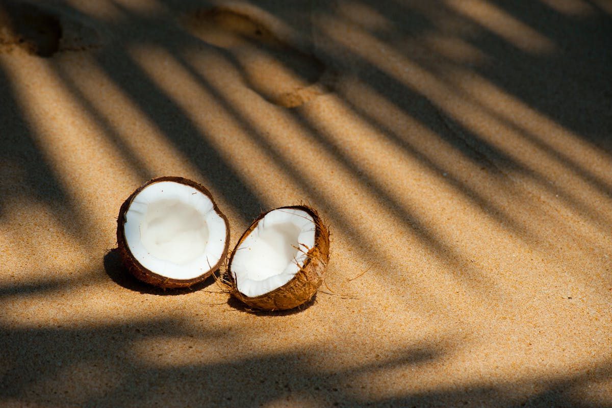 an open coconut on beige blanket