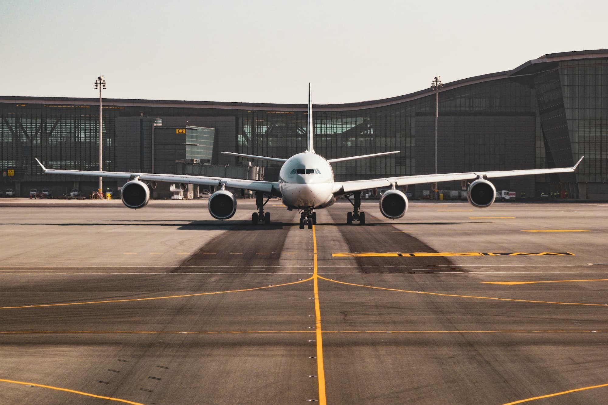 white airplane docked at terminal