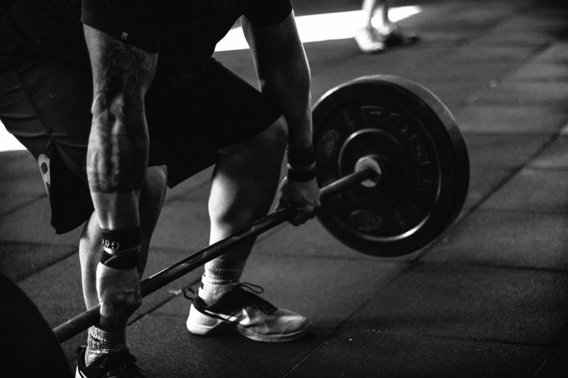 Man lifting barbell with weights