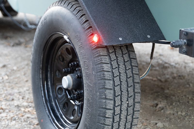 Closeup of the tire on a Bean Stock 2.0 teardrop trailer.