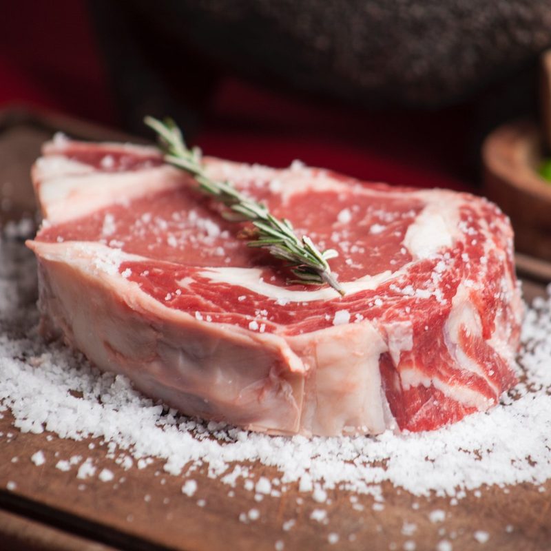Raw steak on cutting board
