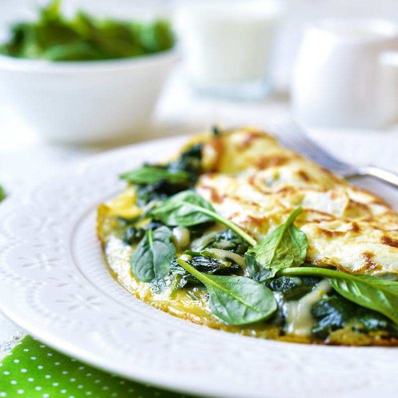 Omelet stuffed with spinach and cheese for a breakfast