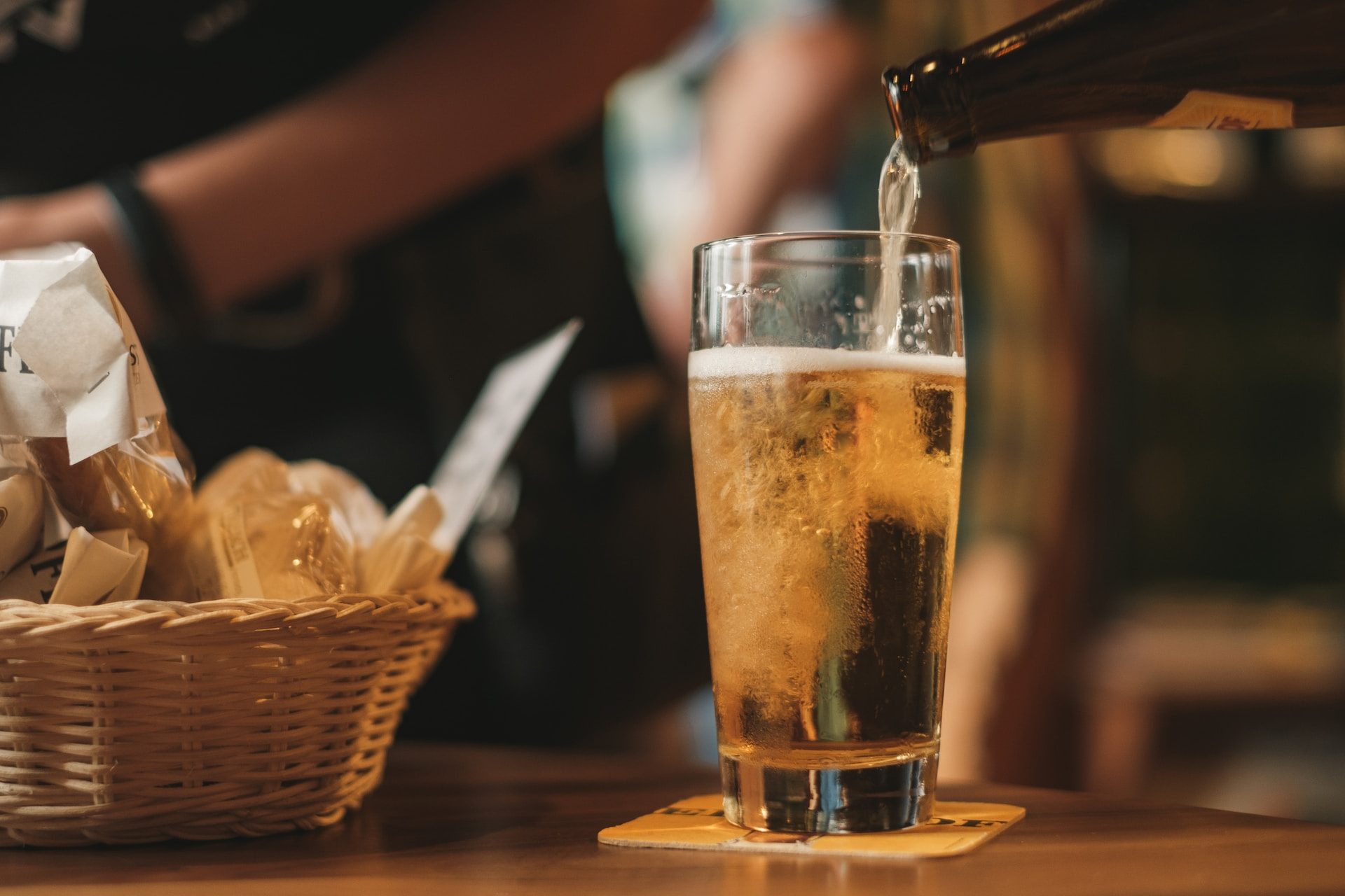 Pouring beer with chips in the background