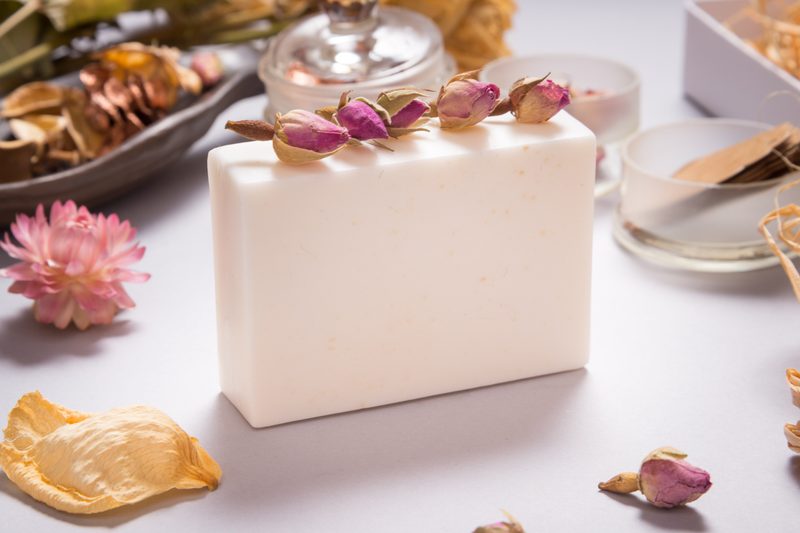 White goat milk handmade soap on grey background