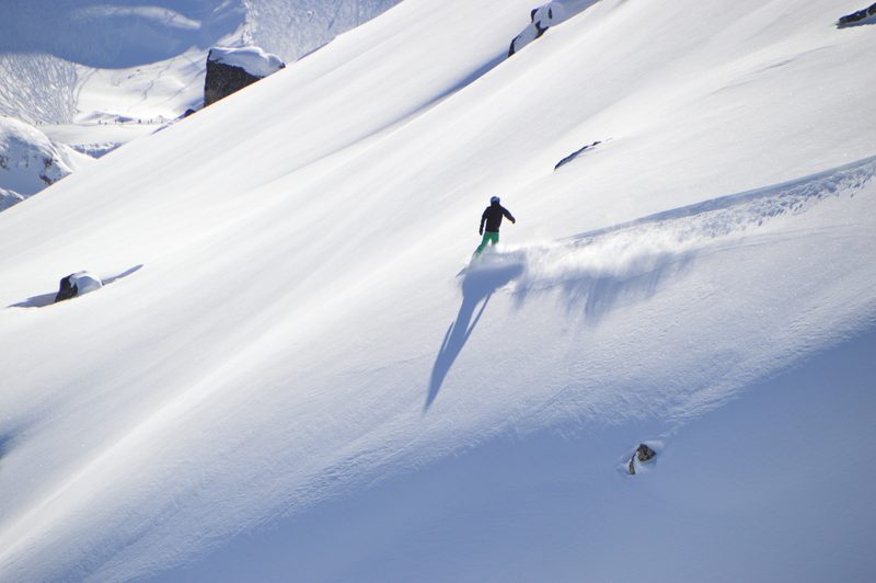 Snowboarder through powder
