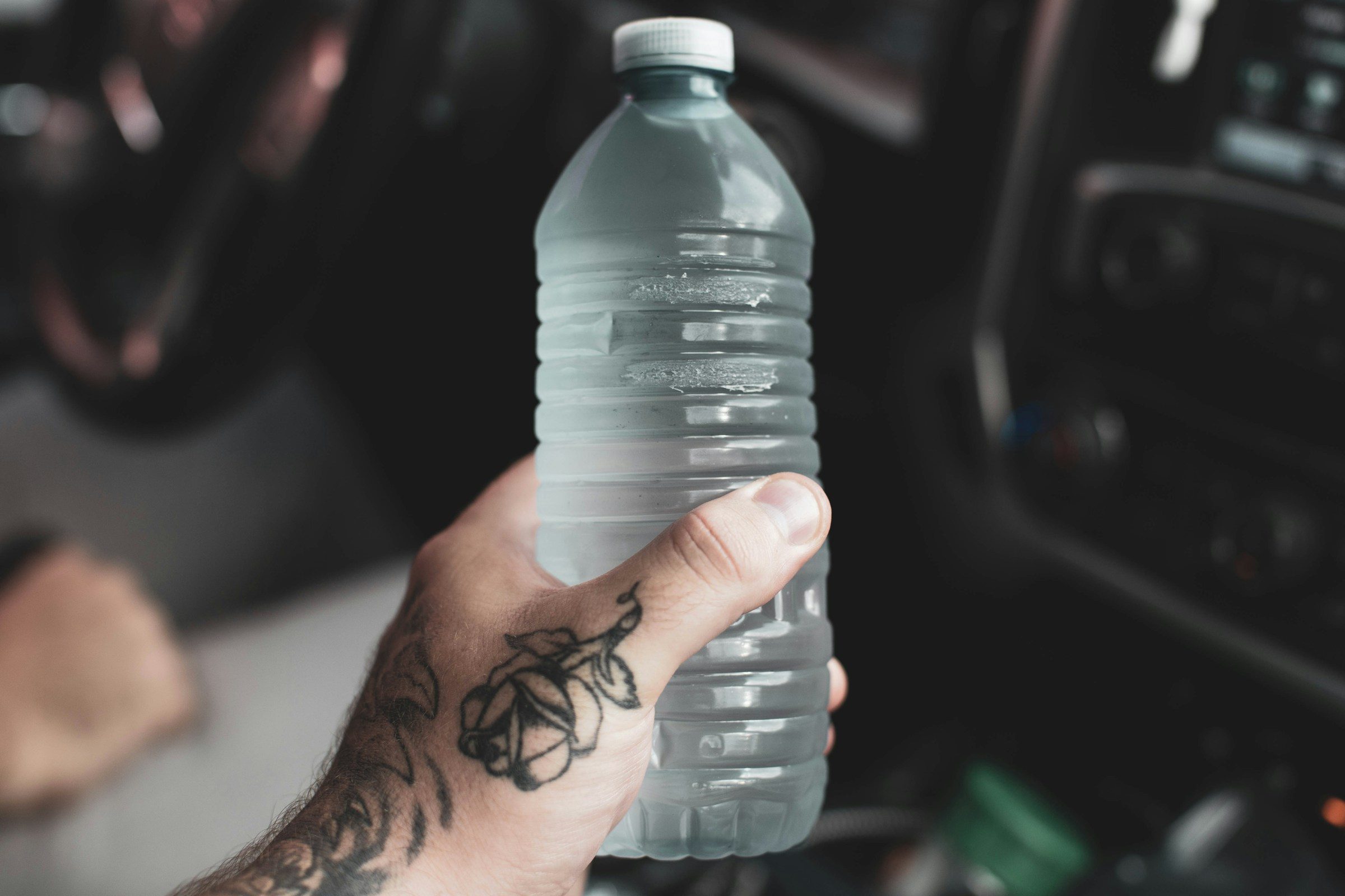 Hand holding water bottle