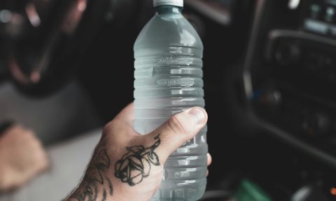 Hand holding water bottle