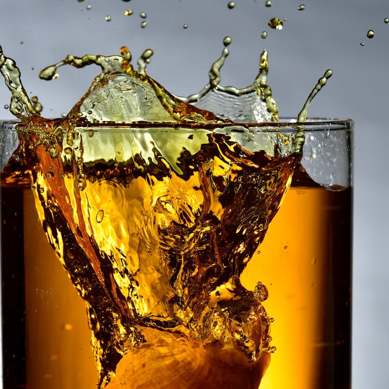 Whiskey splashing from a glass