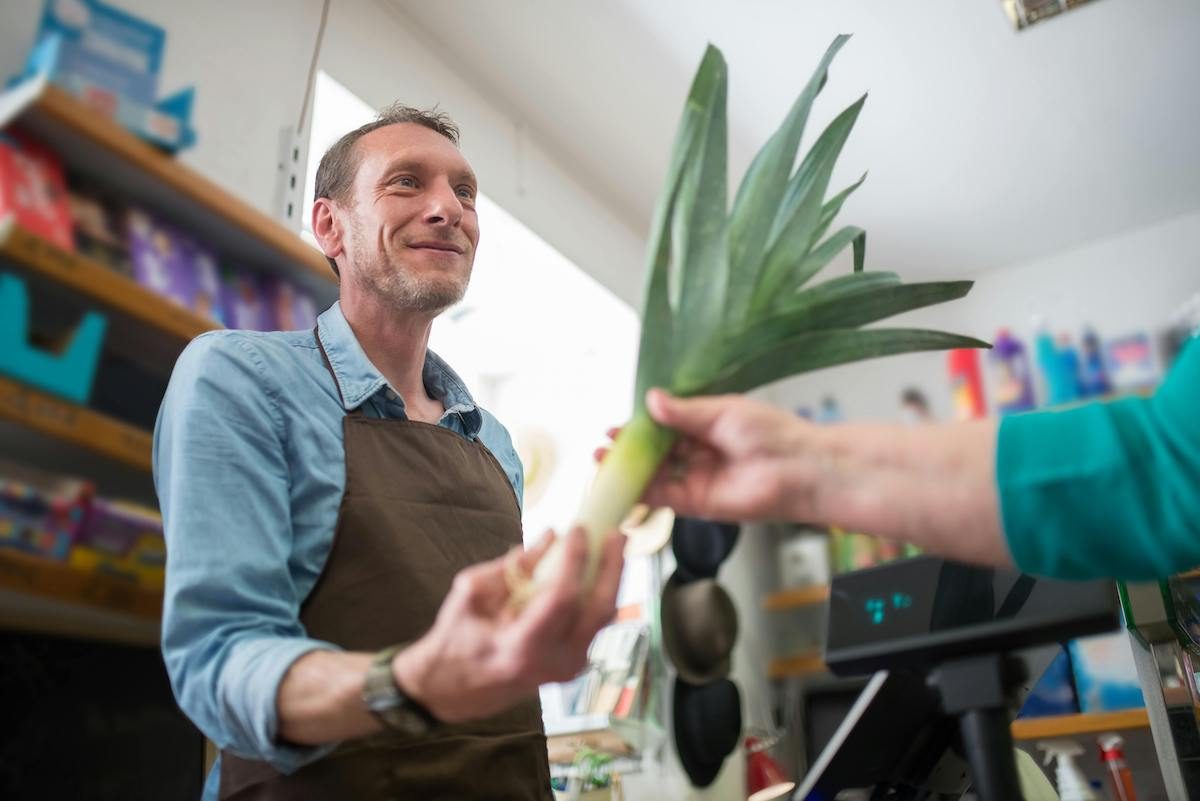a man getting produce at market