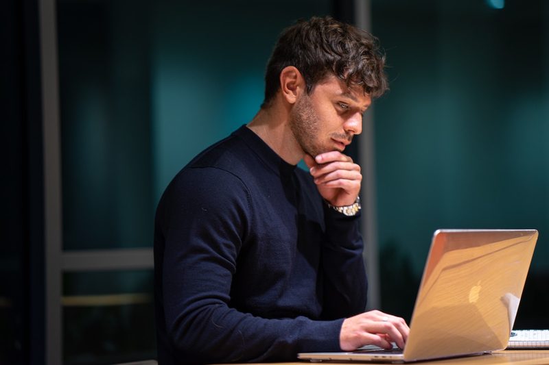 A man staring at a computer