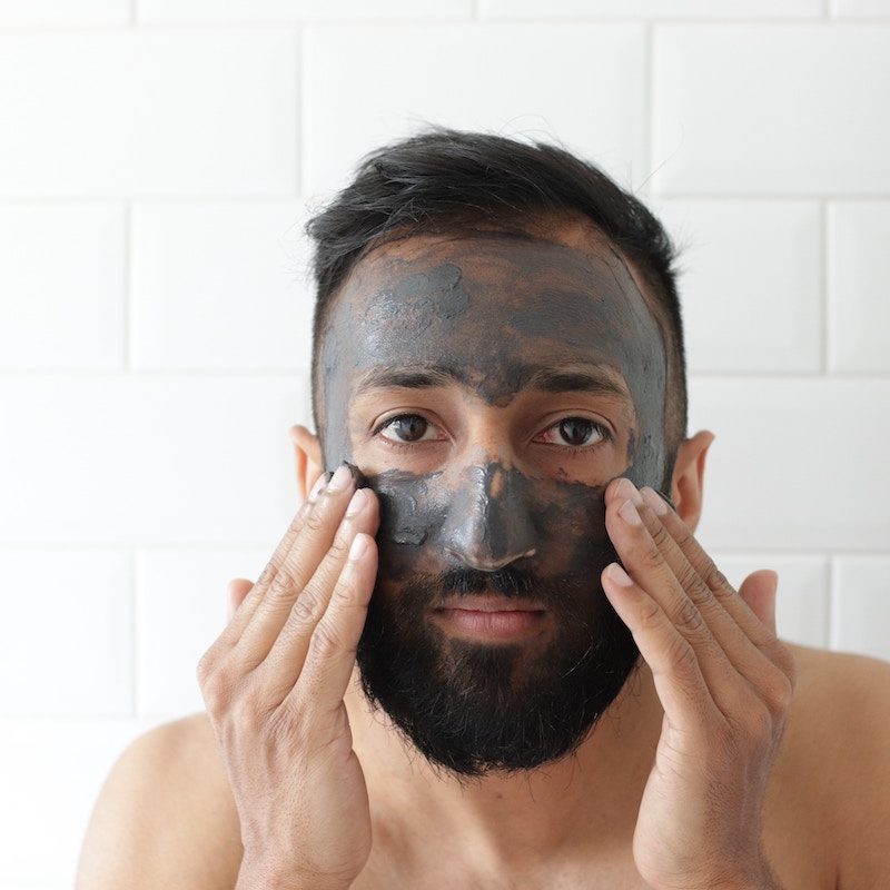 A man applying a face mask