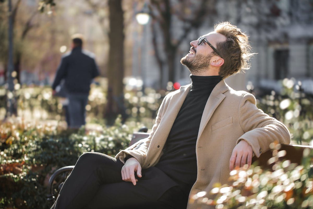 a man with full hair in a park