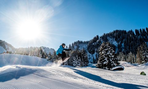 Snowboarder going off jump