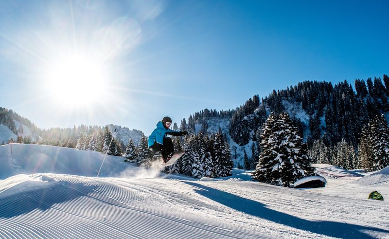 Snowboarder going off jump
