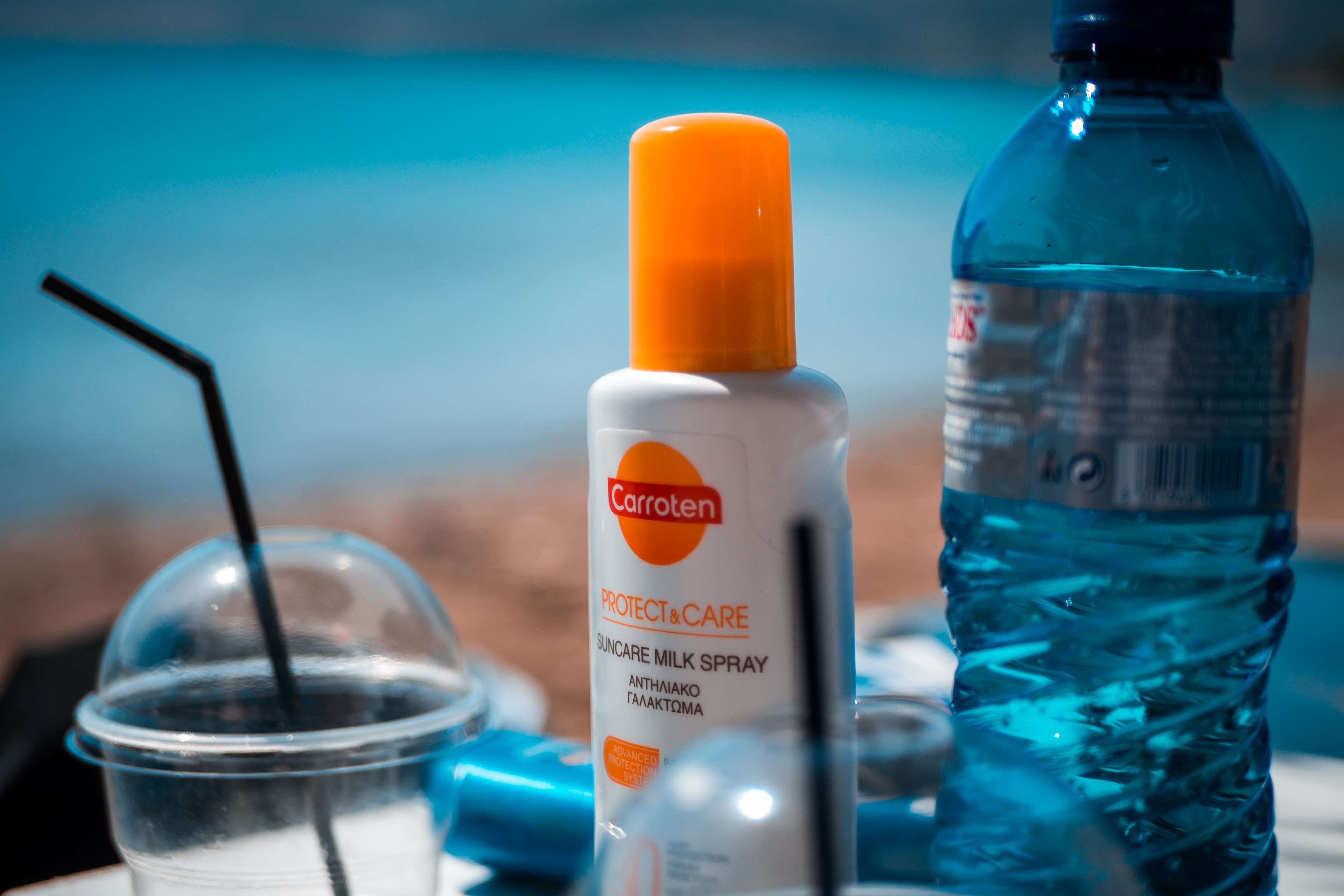 sunscreen next to water bottles