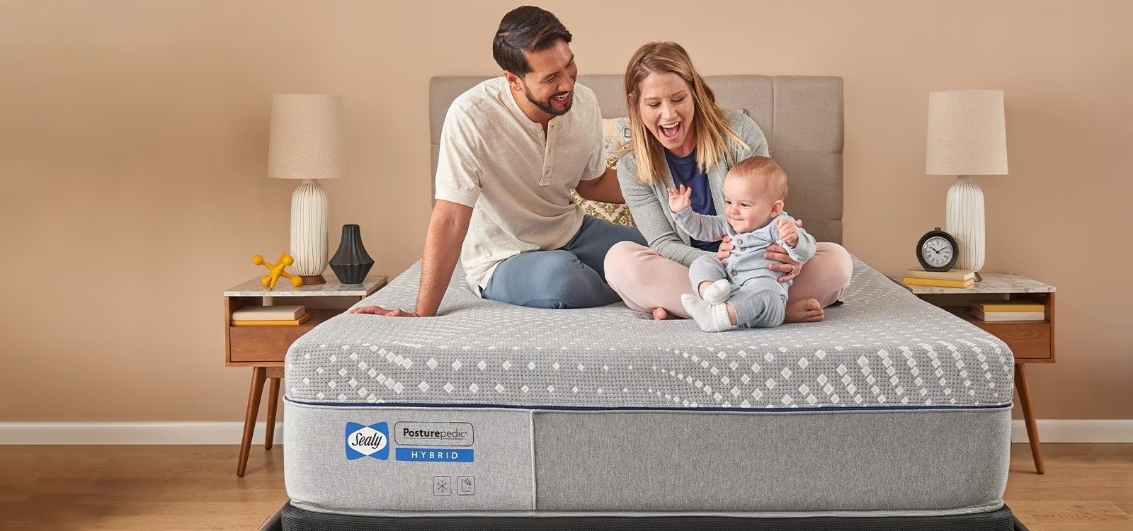 Family sitting on Sealy Posturepedic Hybrid mattress