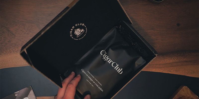 Someone looking at the Cigar Club packaging.
