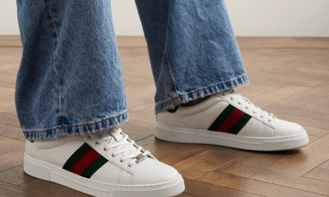 A man wearing the Ace tennis sneakers.