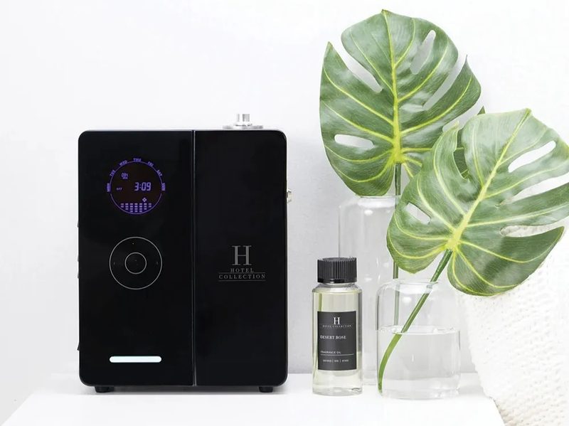 Hotel Collection Penthouse scent diffuser with oils and leaves on a table.