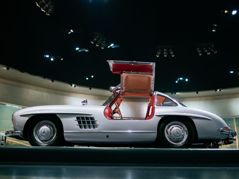 Mercedes-Benz 300 SL Coupe on display at the Mercedes-Benz Museum view from the left side of the car with gullwing doors open.