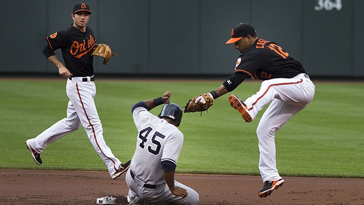 The Baltimore Orioles attempt to tag out a member of the New York Yankees.