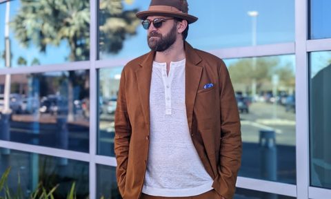 Orange linen suit and trelby hat