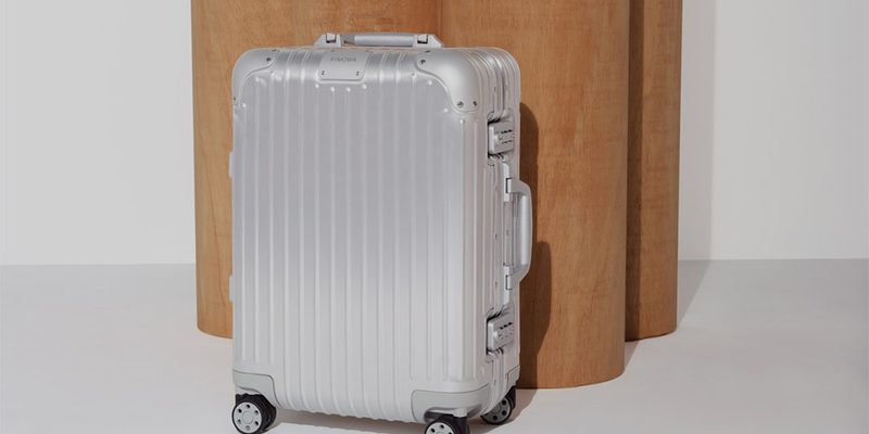 The Rimowa Original Silver next to a door.
