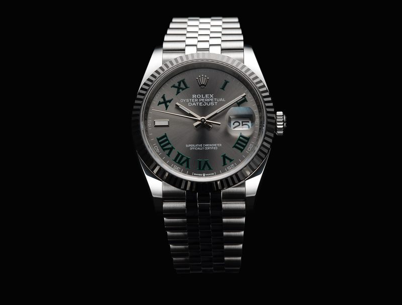 A Rolex watch against a black background.
