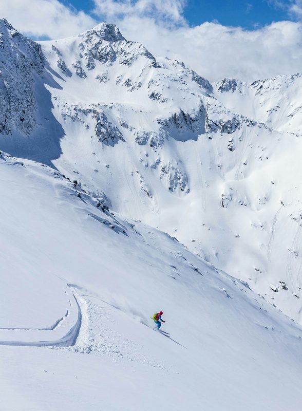 Skier among big mountain terrain