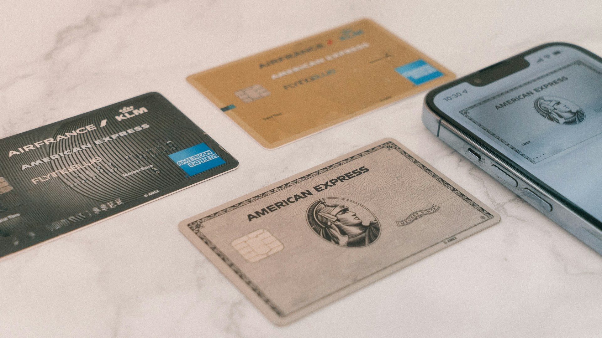 three american express cards on table