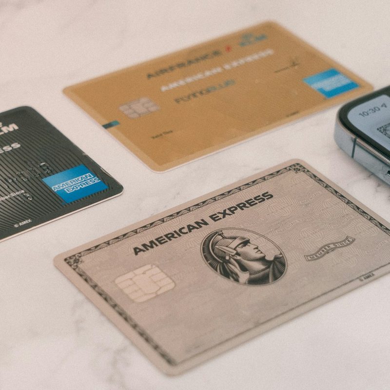 Three American Express cards on a table