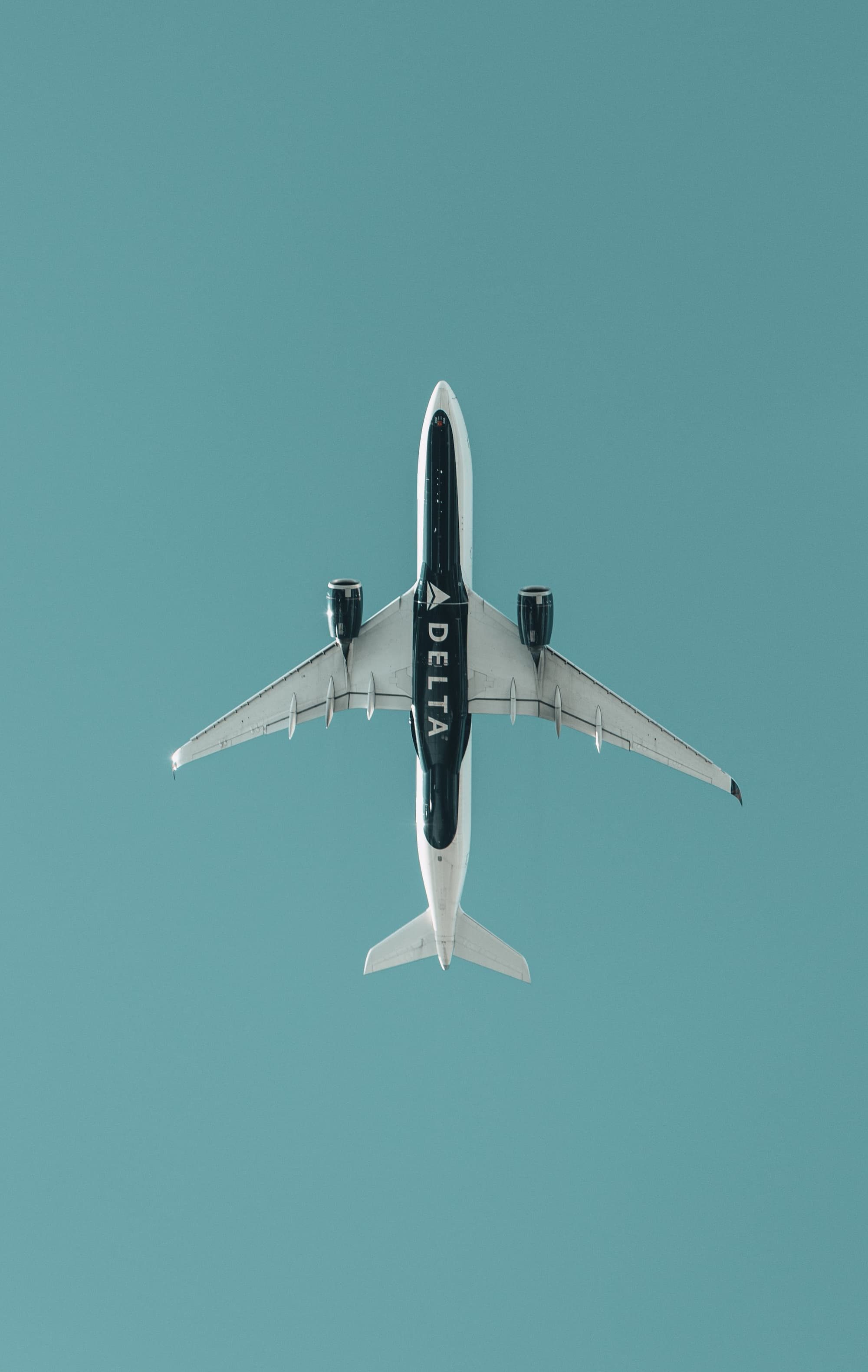white and black airplane in mid air