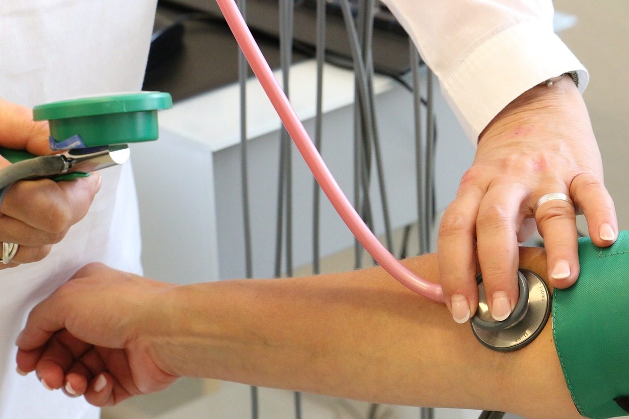 Measuring blood pressure with stethoscope.