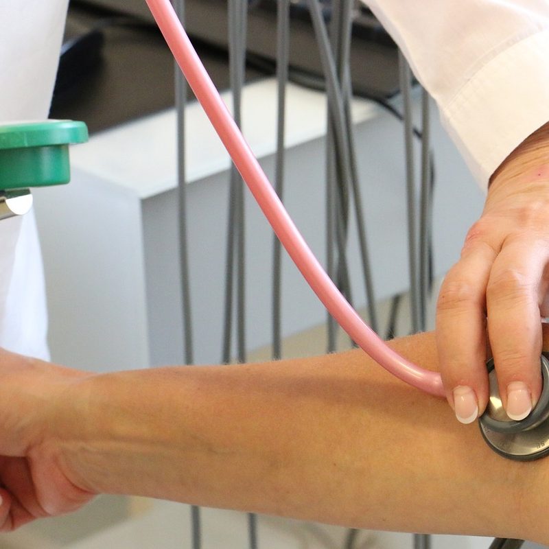 Measuring blood pressure with stethoscope.