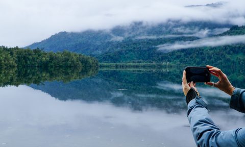 A person taking a picture of the beautiful environment