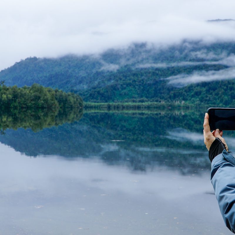 A person taking a picture of the beautiful environment