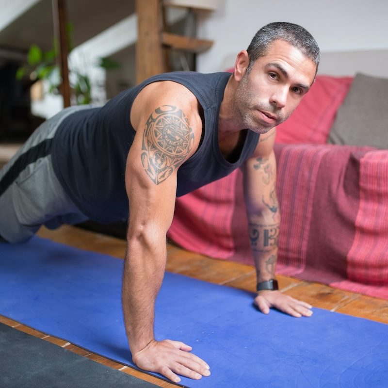 Man doing plank on a yoga mat