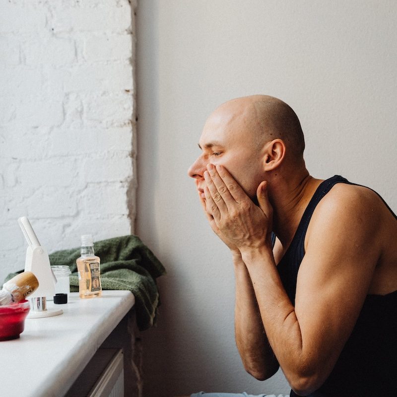 Man putting on skincare product