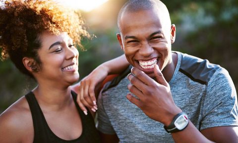 A man and woman laughing after a workout