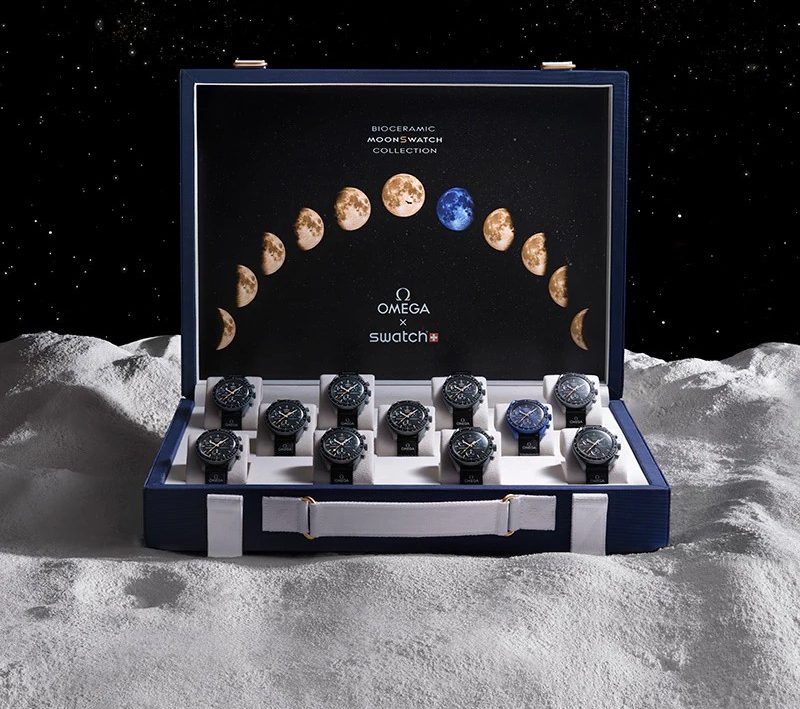 The collection of MoonSwatch watches in the case.