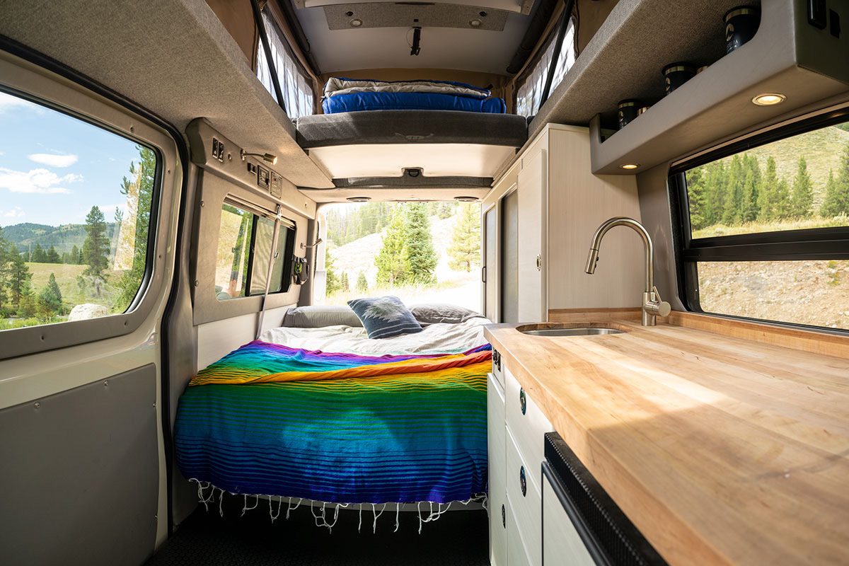 Bed and rear sleeping quarters of a Moterra Campervans rental van.