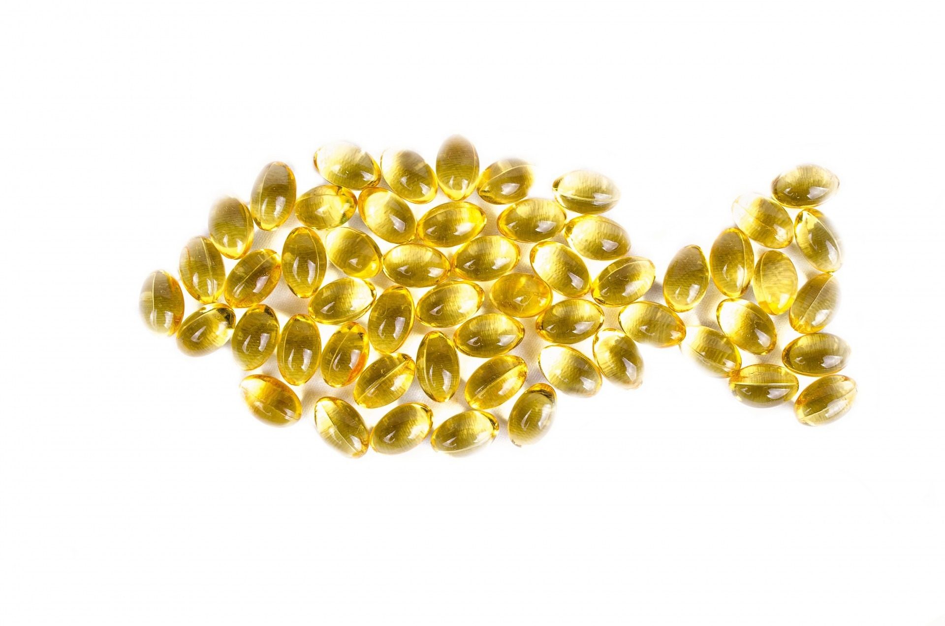 fish oil supplement in shape of fish on white background